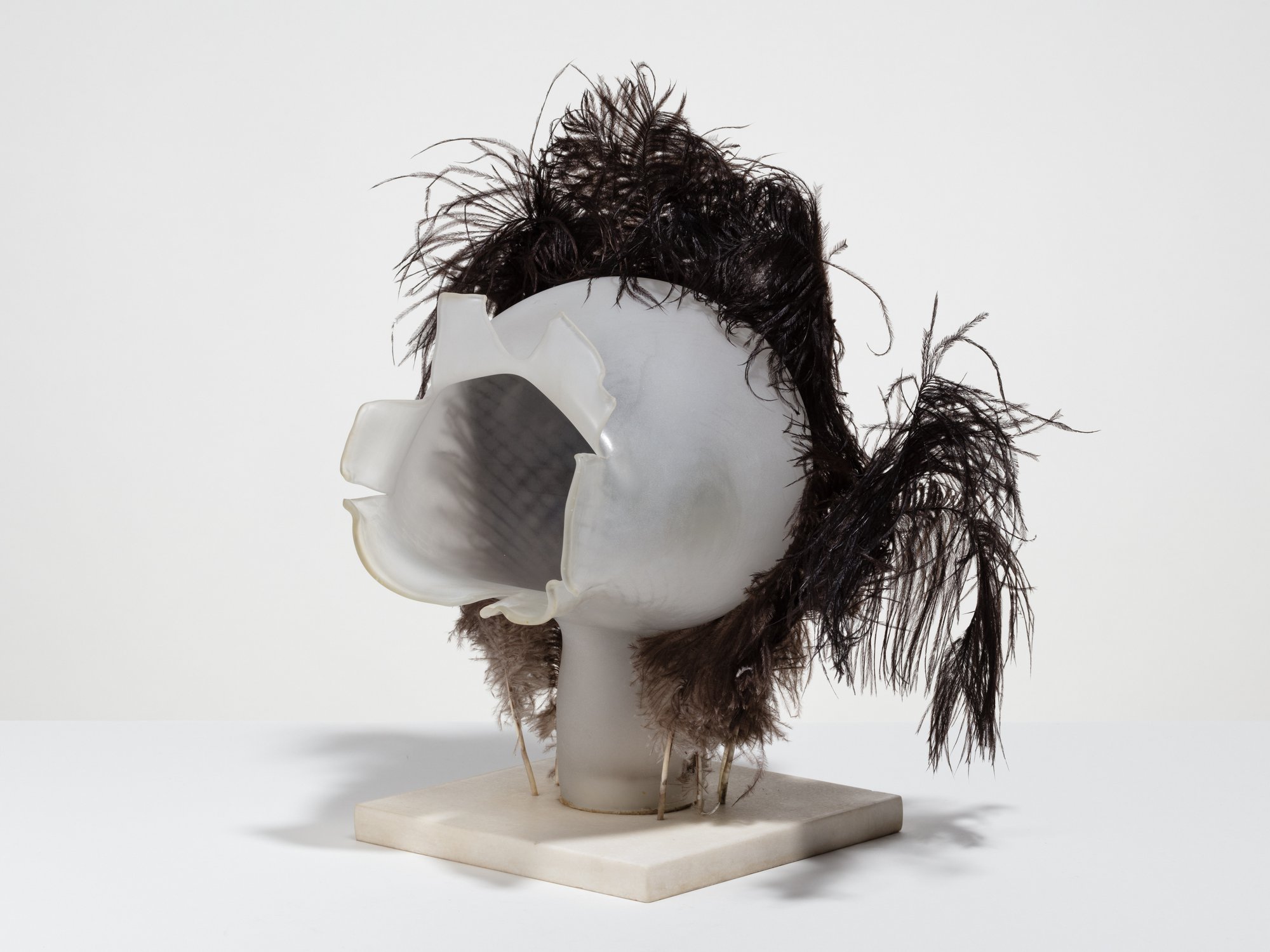 Liliane Lijn, Bridal Wound, sand blasted blown glass, ostrich feathers, white marble base, 38 x 35 x 27 cm, 1986 – 1990