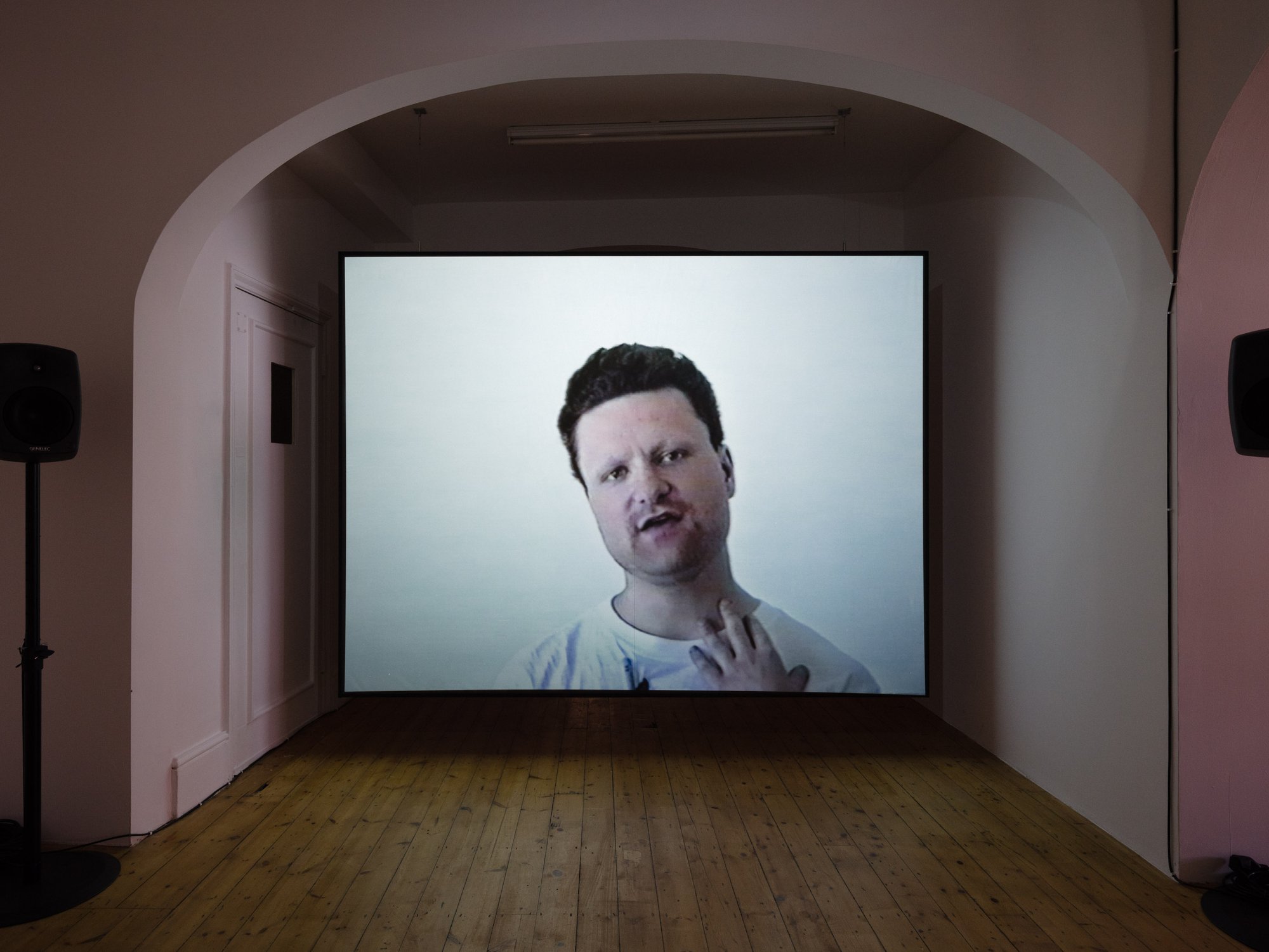 Mark Aerial Waller, Interview with a Nuclear Contract Worker, 2-channel video with parametric speakers, 14 min. and 19 min., 1999. Installation view, Leave nothing behind but your footprints and take nothing but your time, RODEO, London, 2018