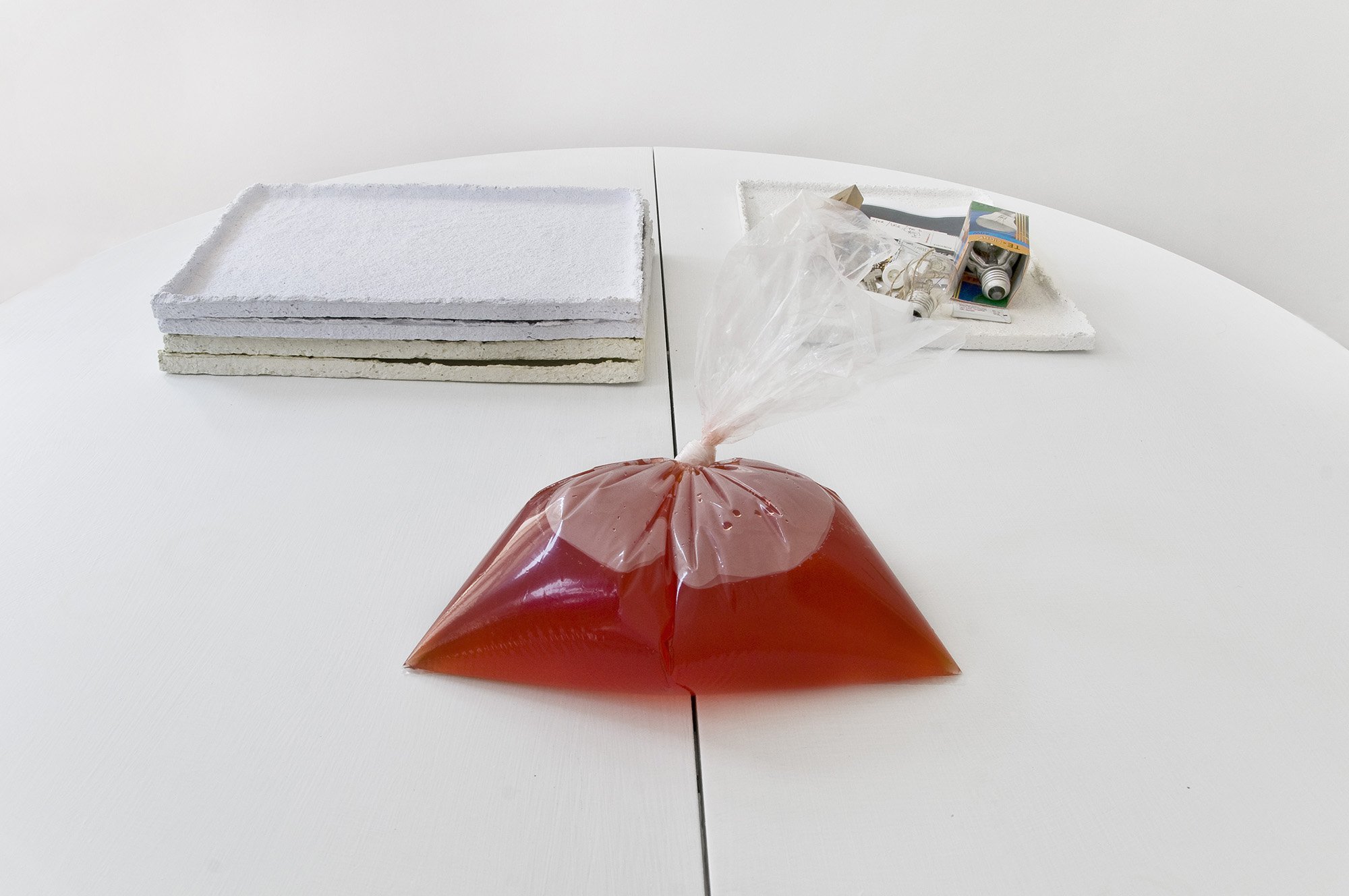 Ian Law, run off, residual water, paper dye, baking powder, adhesive in plastic bag, 2012. Installation view, Make Sure, Rodeo, Istanbul, 2012