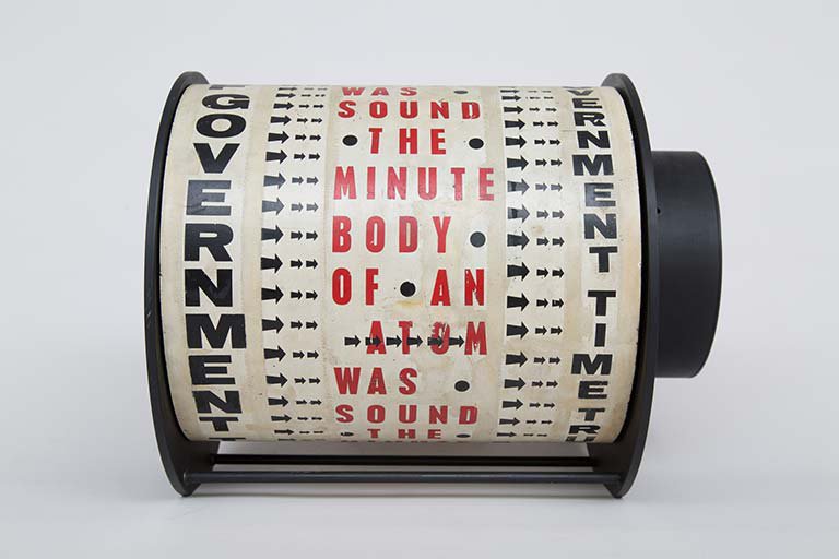Liliane Lijn, Get Rid of Government Time, Letraset on painted metal drum, plastic, painted metal, motor, words from a poem by Nazli Nour, 29.5 x 38 x 30 cm, 1962