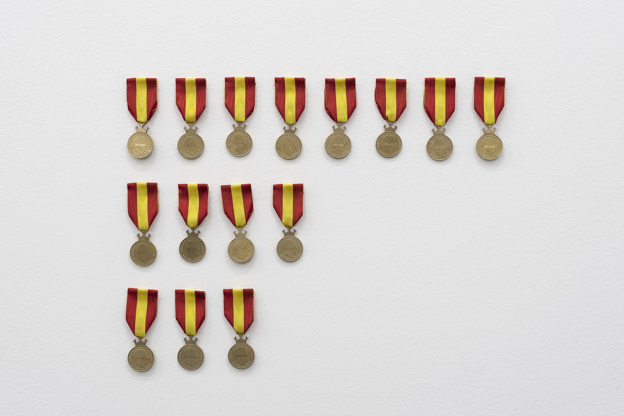 Sidsel Meineche Hansen, SECURE (Bergen Kunsthall), 15 medals of merit, stamped in nordic gold with engraving, 2021