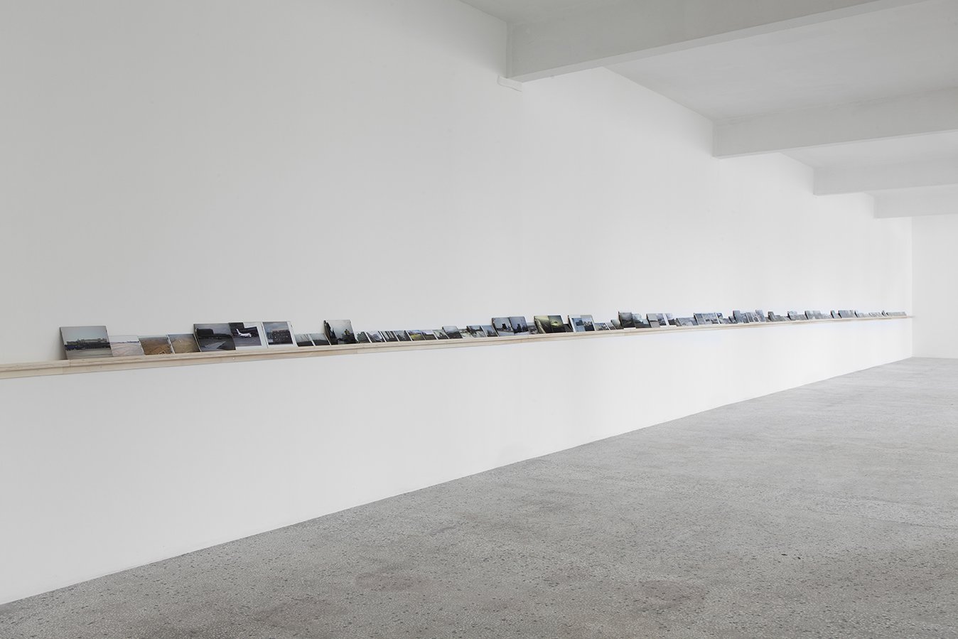 Vangelis Vlahos, Is There Any Oversight On Ocalan?, 119 photographs (framed), dimensions variable (biggest 24 x 30 cm, smallest 10 x 15 cm) on a wall mounted shelf (23 m long), 2009-2011