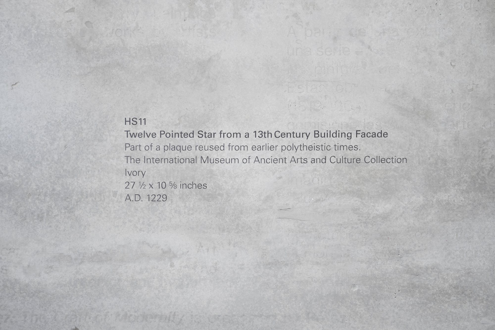 Iman Issa, Heritage Studies #11, blackened wood, two painted white plinths, vinyl text, 195 x 160 cm, 2015