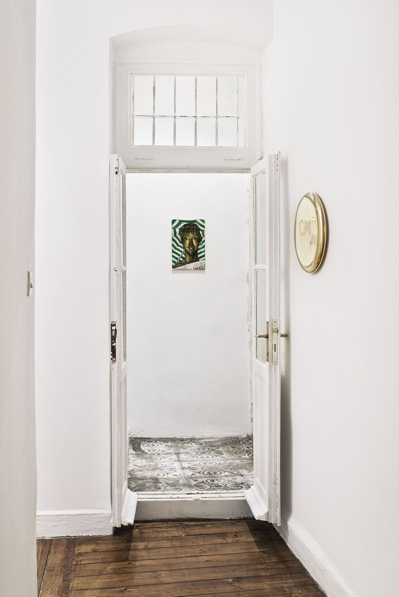 (Centre) Lukas Duwenhögger, Herald, oil on cotton drill, 45 x 29 cm, 1997, 2012; (Right) Michael Anastassiades, Mirror, polished metal, 39 cm (dia.). Installation view, All That Shines Ain’t No Gold, Rodeo, Istanbul, 2012