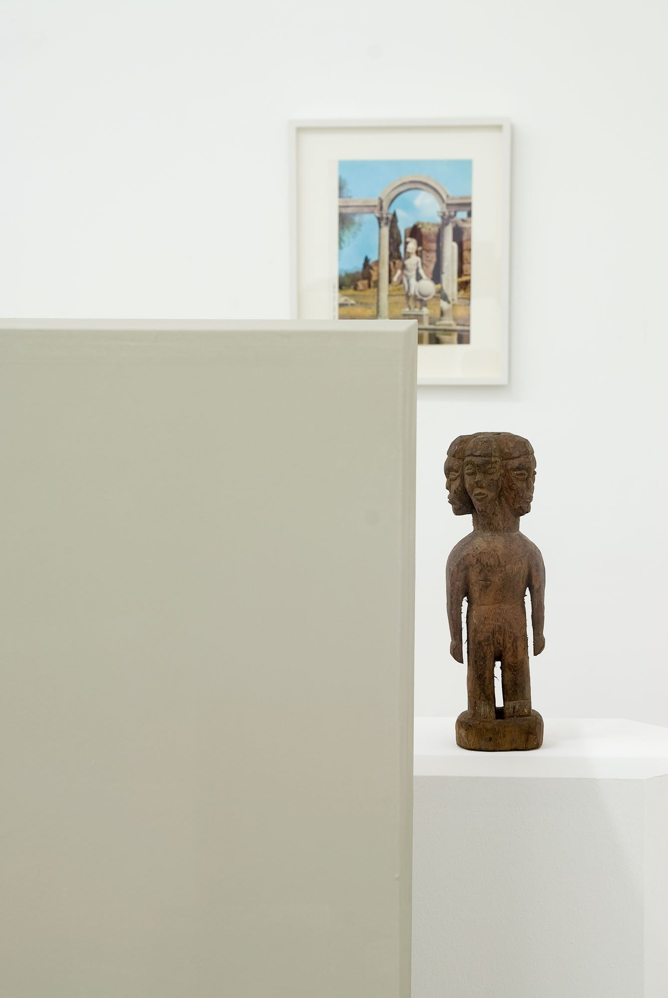 Haris Epaminonda, detail, installation with two plinths (143 x 34.6 x 35.3 cm and 107 x 29.9 x 21.1 cm), African found statuette (height: 26 cm) and framed image (28.7 x 34.4 cm). Installation view, VOL. IV, Rodeo, Istanbul, 2009