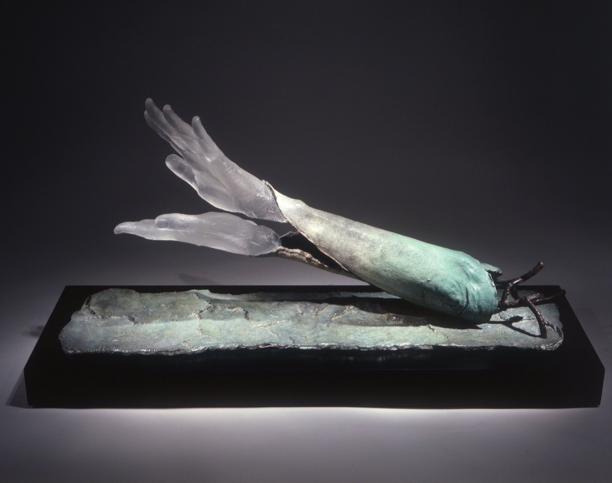 Liliane Lijn, She Me Skin of the Tree, Ayres Rock Gum tree bark cast artist’s arm and hand, patinated bronze, cast glass, 27 x 63.5 x 16.5 cm (10 5/8 x 25 x 6 1/2 in), 1999